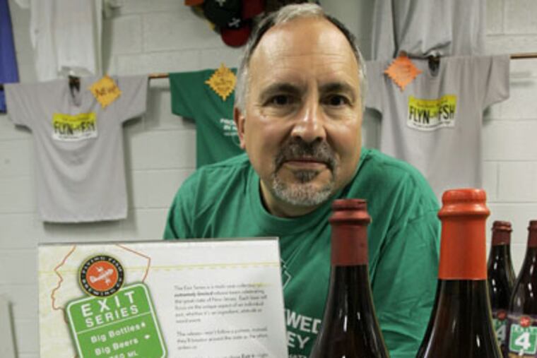 Gene Muller, founder and president of Flying Fish Brewing Co., with bottles of Exits 4 and 11 at the company headquarters in Cherry Hill. Muller's idea has not found favor with the Turnpike Authority or New Jersey's Mothers Against Drunk Driving chapter. (AP Photo / Mike Derer)