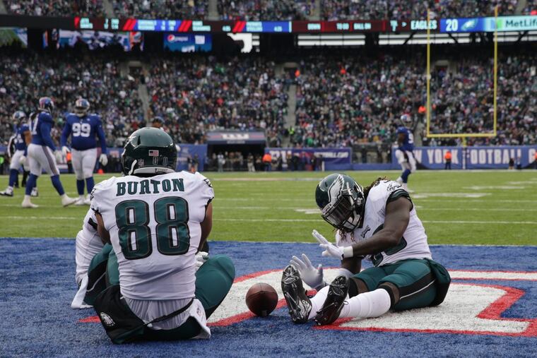 The Eagles are sitting pretty heading into Week 16 as Jay Ajayi, right, joins Trey Burton for a campfire/touchdown celebration during Sunday’s win over the Giants. DAVID MAIALETTI / Staff Photographer