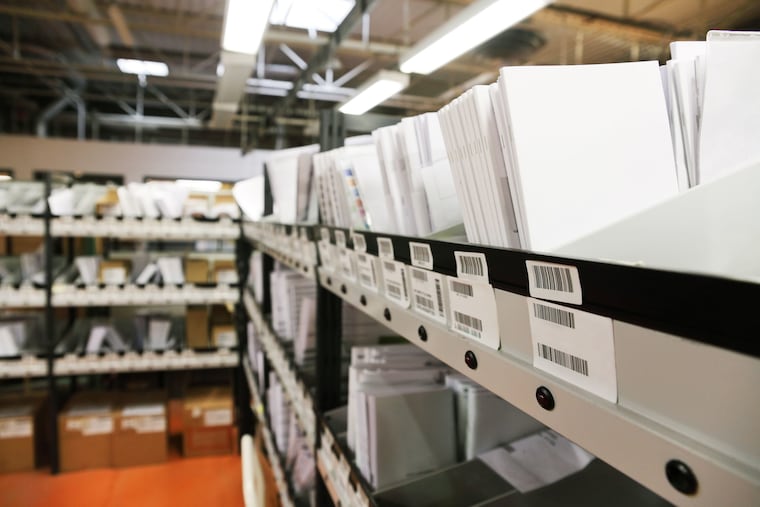 A warehouse with shelves of office supplies is shown in this stock photo. Essendant, which sold office supplies and recently shifted toward other products, plans to close a local facility.