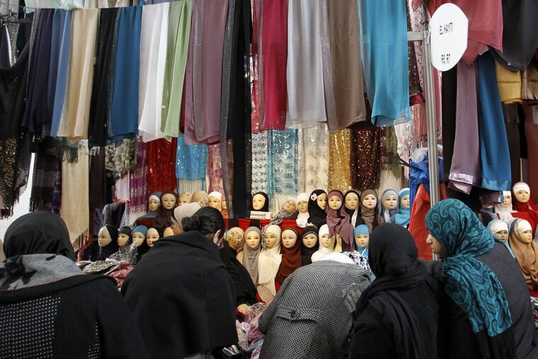 In this Dec.17, 2011 file photo, women look at veils on display at an exhibition hall for the Muslim World Fair in Le Bourget, outside Paris. Le Pen’s refusal to don a white headscarf ahead of a meeting this week with Lebanon’s grand mufti, underscored how serious she is about enacting a stringent dress code that would risk stigmatizing France’s large Muslim population anew and force the nation’s Jews to give up one of their own cherished customs.