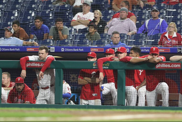 Phillies players watch from the dugout in the 10th inning of Tuesday night's doubleheader finale.