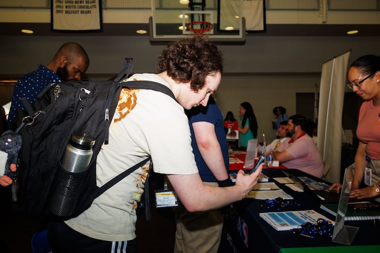 Jimmy Myers, a freshman interested in pursuing a career in transportation, scans a QR code at the Spring Career Fair at Drexel University.