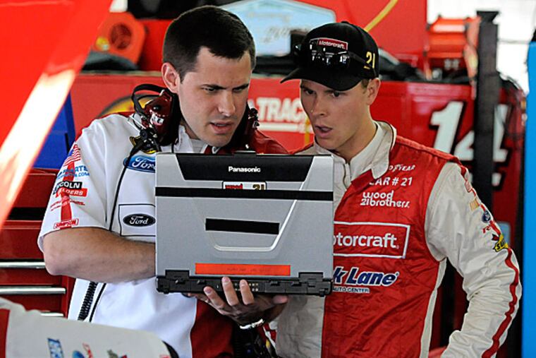 Trevor Bayne talks to a crew member. (Mike McCarn/AP)