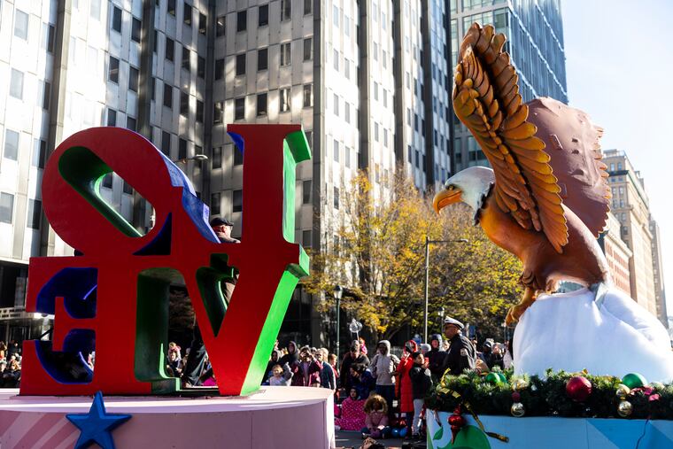 The Love sign and Eagle Float passes by near City Hall during the 2022 Thanksgiving Day Parade in Philadelphia.