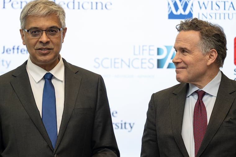 National Institutes of Health director Jay Bhattacharya (left) and Sen. David McCormick (R., Pa.) speak to members of the media Tuesday after touring University of Pennsylvania facilities to highlight NIH-funded research in Philadelphia.