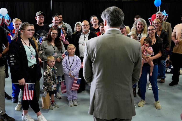 Deputy Secretary of State Christopher Landau greets Afrikaner refugees from South Africa at Washington Dulles International Airport in Virginia on Monday.