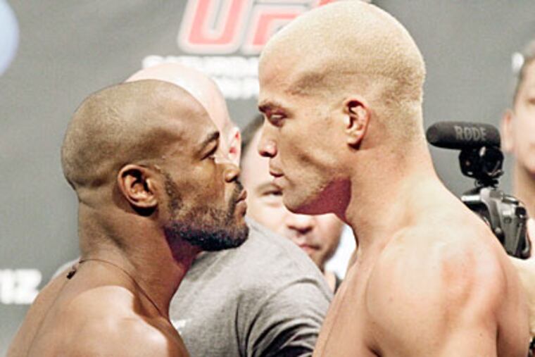 Rashad Evans, left, and Tito Ortiz stare each other down during UFC weigh-ins. (Elizabeth Robertson/Staff Photographer)