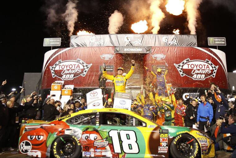 Kyle Busch, center, celebrates in Victory Lane after winning the NASCAR Cup Series auto race at Richmond Raceway in Richmond, Va., Saturday, April 21, 2018.