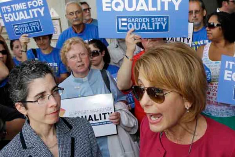 State Sen. Barbara Buono speaks to advocates for gay marriage in New Jersey at a gathering outside the Statehouse Thursday, June 27, 2013, in Trenton, N.J., as they say they'll press their case in the Legislature and the courts after the U.S. Supreme Court ruling that invalidates parts of the federal Defense of Marriage Act. Gov. Chris Christie said he would again veto a same-sex marriage bill if it reaches his desk, and that Wednesday's U.S. Supreme Court ruling striking down a ban on federal benefits for same-sex married couples will have no effect on New Jersey, one of a handful of states that allows civil unions. Buono, the Democrat running against Christie for governor and the parent of an adult gay daughter, called for an override of Christie's veto. (AP Photo/Mel Evans)