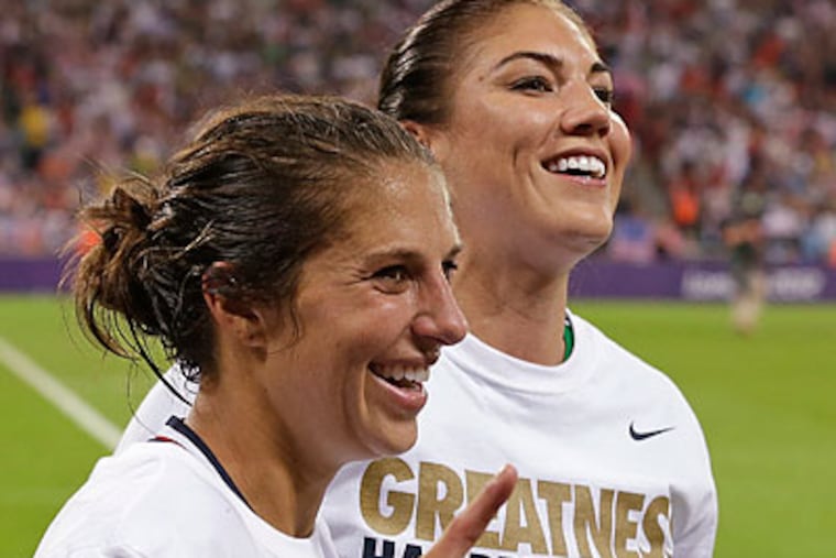 Carli Lloyd scored both goals and Hope Solo delivered a shutout in the gold medal game. (Ben Curtis/AP)