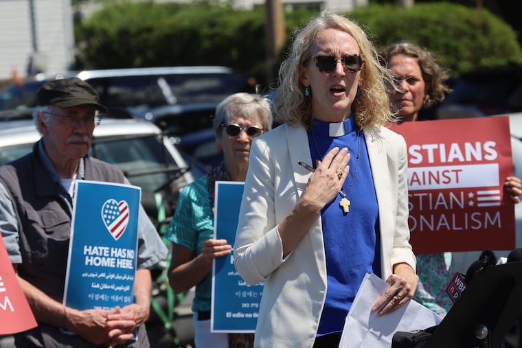 The Rev. Jennifer Butler speaks outside the ReAwaken America Tour stop in Batavia, N.Y., in August. To Butler, the event underscored how little Christian nationalism has to do with Christianity, she writes.
