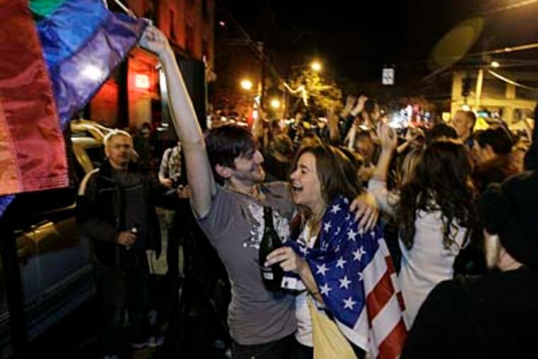 Revelers display U.S. and gay pride flags as they celebrate early election returns favoring Washington state Referendum 74, which would legalize gay marriage, during a large impromptu street gathering in Seattle's Capitol Hill neighborhood, in the early hours of Wednesday, Nov. 7, 2012. (AP Photo/Ted S. Warren)