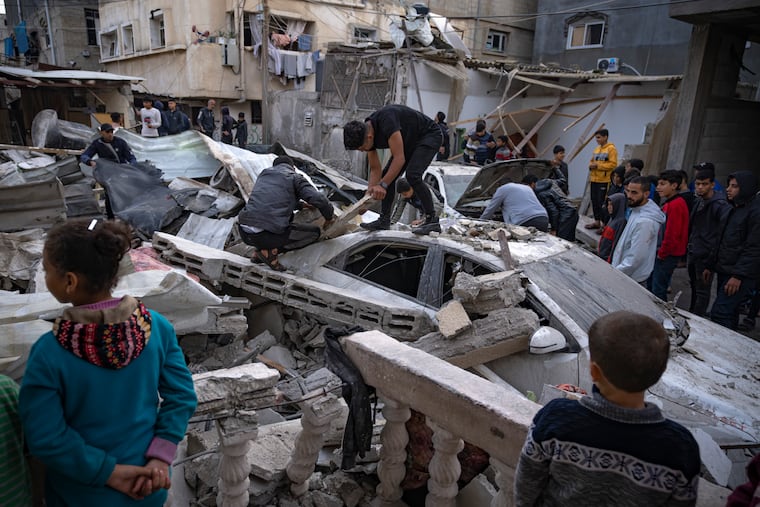 Palestinians inspect a house after it was hit by an Israeli bombardment on Rafah, southern Gaza Strip, Wednesday, Dec. 20, 2023.
