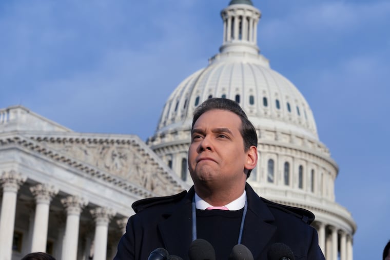 Rep. George Santos, R-N.Y., faces reporters at the Capitol in Washington on Thursday. After a scathing report by the House Ethics Committee citing egregious violations, Santos could be expelled from Congress this week.