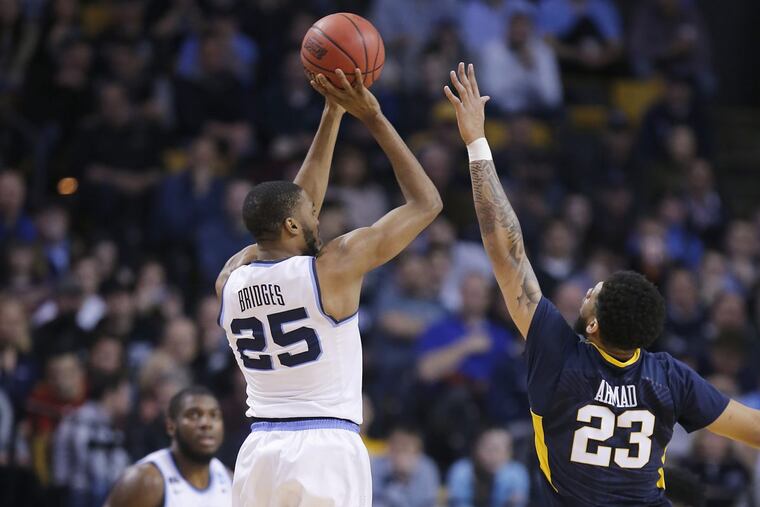 Mikal Bridges of Villanova shoots a 3-pointer against Esa Ahmad of West Virginia during the 2nd half of the East Regionals of the NCAA Tournament at TD Garden on March 23, 2018.