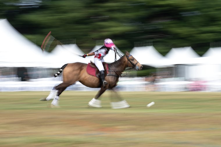 A player pursues the ball during the first polo match of the day at the third annual Philadelphia Polo Classic in Fairmount Park.