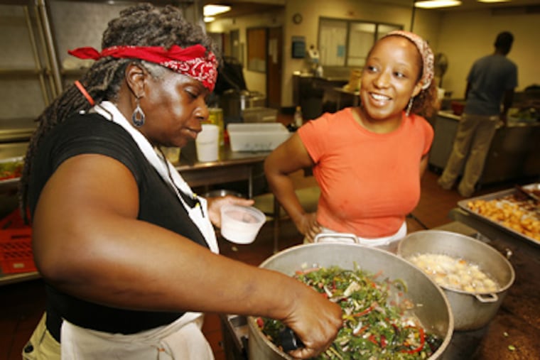Valerie Erwin (left) and Hilary Johnson, of the Geechi Girl Rice Cafe in Mount Airy, helped in serving. (Alejandro A. Alvarez / Staff Photographer)