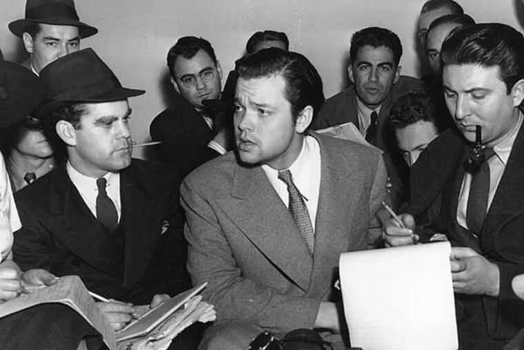 Orson Welles, center, explains to reporters on Oct. 31, 1938 his radio dramatization of H.G. Wells' "War of the Worlds." Meanwhile, Columbia Broadcasting System made public the transcript of the dramatization, which was aired the night of Oct. 30 and caused thousands of listeners to panic because of the realistic broadcast of an imaginative invasion of men and machines from Mars. (AP Photo)