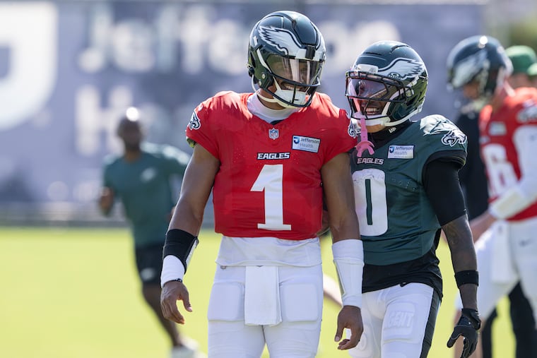 Jalen Hurts (left, with receiver Hollywood Brown) did good things Friday as the new-look Eagles offense continued its evolution.
