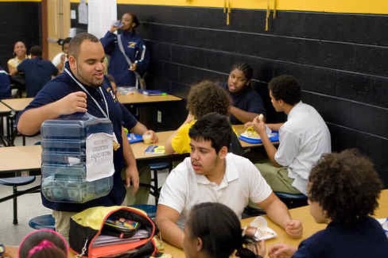 Carrying a collection jug, Jimmy Butler, 17, seeks donations for Haitian relief in the Lindenwold High School cafeteria. Guidance director Leanna Sykes said about $800 had been raised by yesterday.
