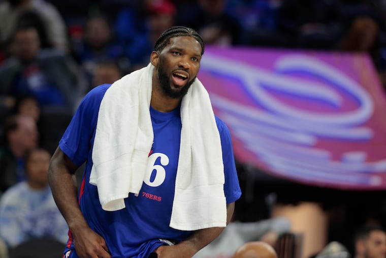 Joel Embiid cheers on his Sixers teammates during their game against the Pistons on Jan. 10 at the Wells Fargo Center.
