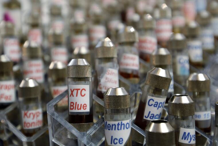 FILE – This Dec. 4, 2013 file photo shows vials of flavored liquid at a store selling electronic cigarettes and related items in Los Angeles. On Wednesday, Sept. 12, 2018, U.S. health officials said teenage use of e-cigarette has reached "epidemic" levels in the U.S. and are calling on the industry to address the problem or risk having their flavored products pulled off the market. (AP Photo/Reed Saxon, File)