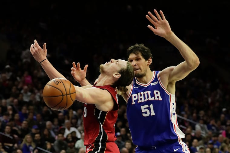 Sixers center Boban Marjanovic fouls Miami Heat forward Kelly Olynyk during the fourth-quarter on Thursday, February 21, 2019 in Philadelphia.