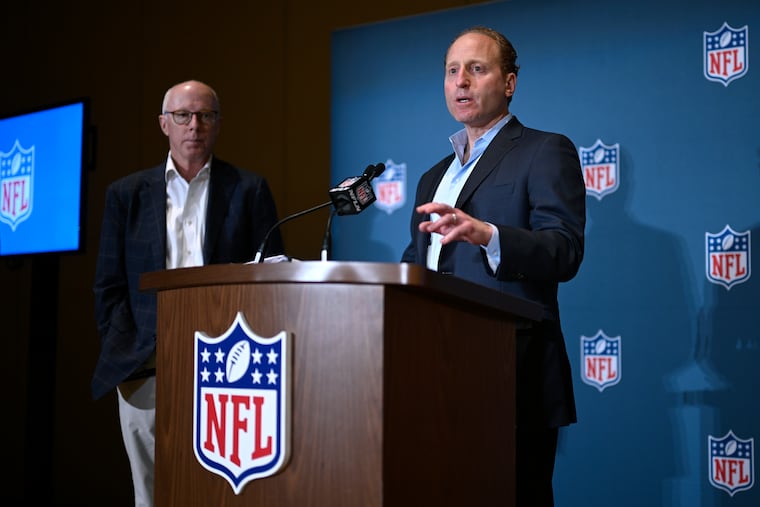Rich McKay, left, Atlanta Falcons CEO and Competition Committee Chairman, looks on as Jeff Miller, NFL Executive Vice President of Communications, addresses reporters about rules changes at the NFL owners meetings on Monday.