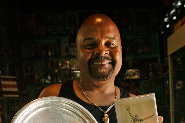 Ronald Toby of Northeast Philadelphia owns a sterling silver plate given years ago to Wilt Chamberlain by the Dapper Dan Club of Pittsburgh.
