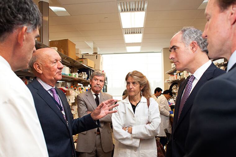 Senator Bob Casey tours the Penn Cardiovascular Institute's research lab at HUP's Perelman Pavilion on Wednesday October 23, 2013. Left to right, Dr. Daniel Rader, professor and chief of the division of translational medicine, Ralph Muller, CEO of UPHS, Dr. Peter Quinn Dr. Jean Bennett, professor of Ophthalmology, Sen. Casey , Dean Larry Jameson, Dean of the Perelman School of Medicine.( Ed Hille / Staff Photographer)