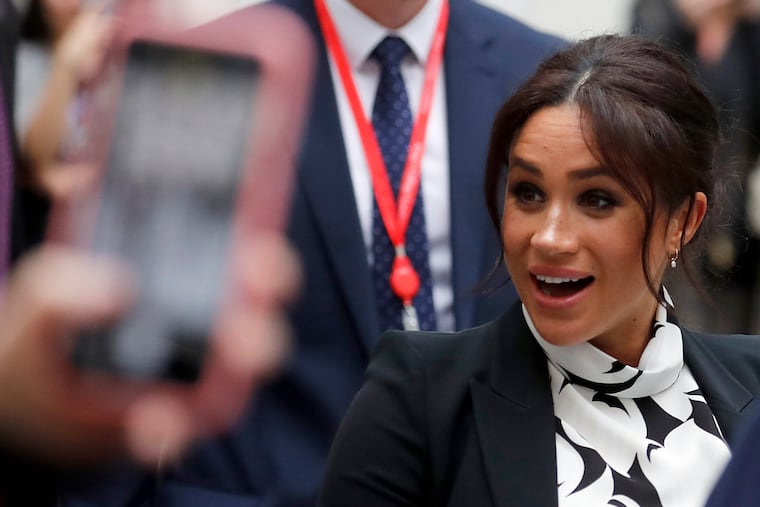 Britain's Meghan, the Duchess of Sussex, leaves King's College after joining a panel discussion convened by The Queen's Commonwealth Trust to mark International Women's Day in London, Friday, March 8, 2019.
