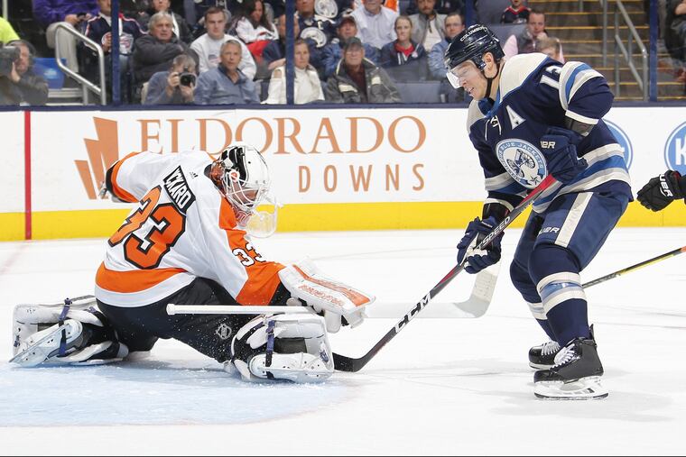 Blue Jackets' forward Cam Atkinson (13) takes on Flyers' goalie Cal Pickard on Thursday.