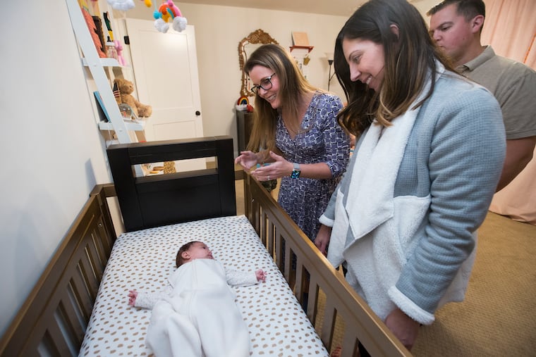 Jennifer Schindele (left) runs through the routine that Debbie Parnes (center) and husband Michael Herman should use to get their daughter, Estie Herman, ready for bed.