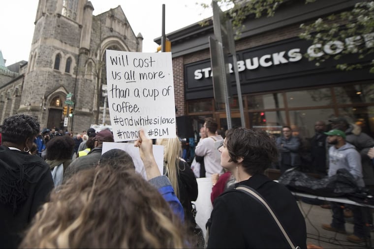 Protesters gathered outside the Starbucks on 18th & Spruce Streets Monday. Two black men were arrested last week in a video incident that went viral over the weekend.