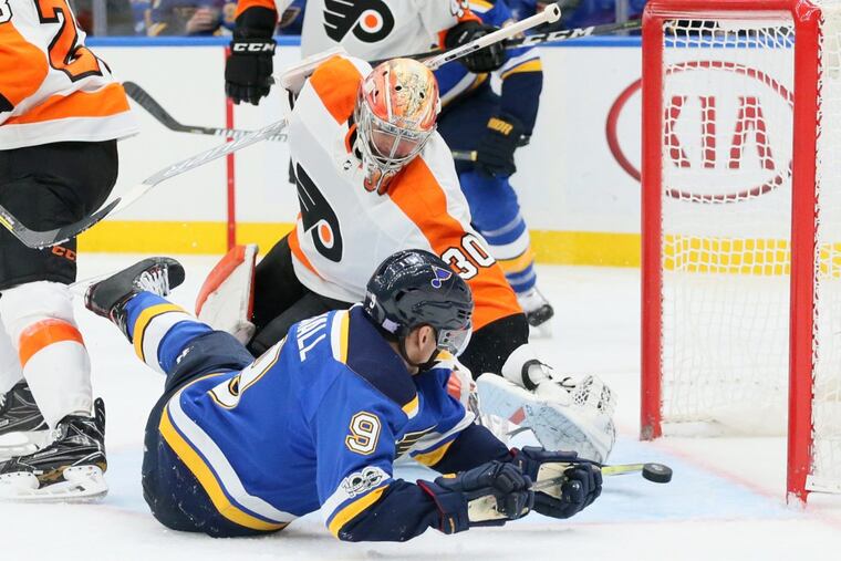 The Blues' Scottie Upshall (9) tries to score against Flyers goaltender Michal Neuvirth in the third period Thursday,.