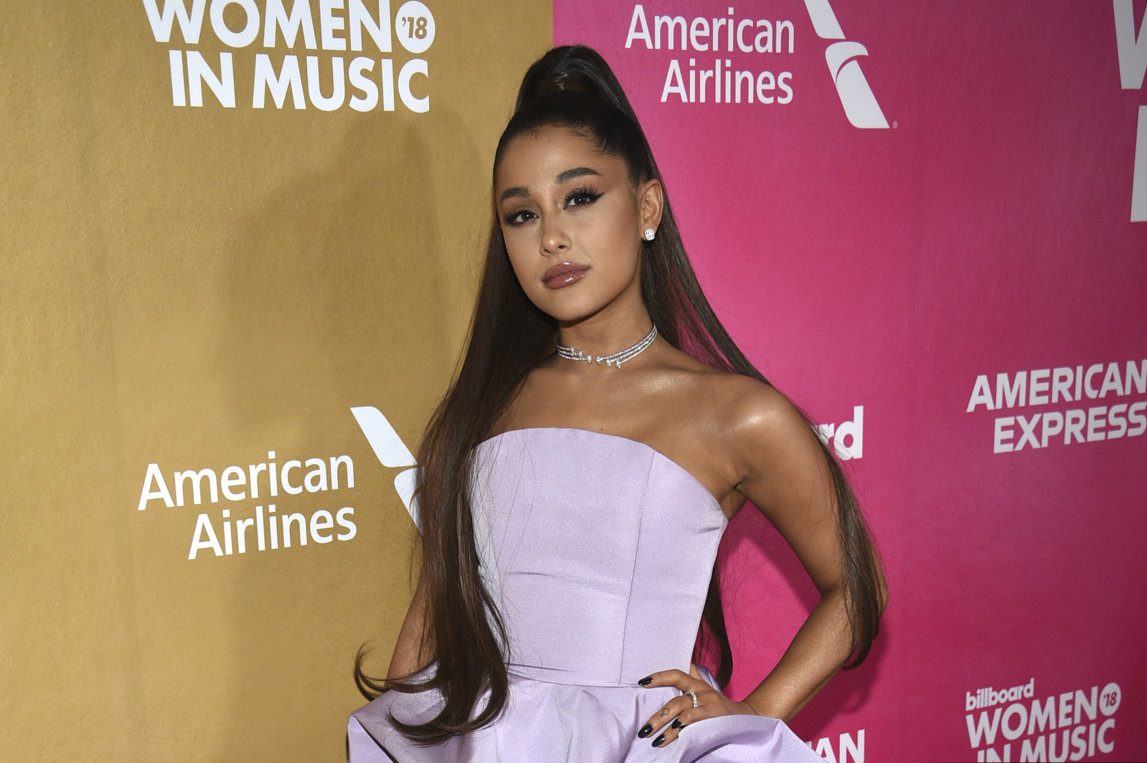 FILE - In this Dec. 6, 2018, file photo, Ariana Grande attends the 13th annual Billboard Women in Music event at Pier 36 in New York. Grande is telling her fans that she has a bad sinus condition that has made her “very sick” and might force her to cancel upcoming shows on her world tour. Grande, 26, says in videos posted on Instagram Saturday, Nov. 16, 2019, that “my throat and head are still in so much pain.”