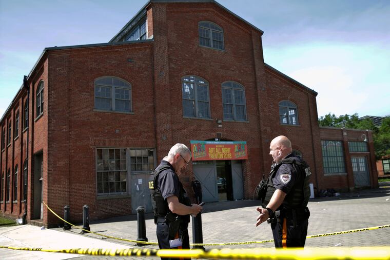 Police stand guard outside the warehouse building where the Art All Night 2018 festival was held in Trenton last June.