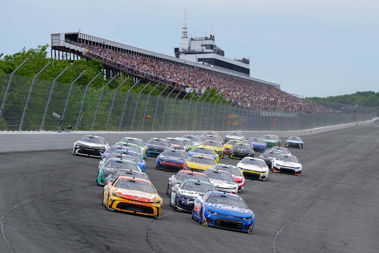 Denny Hamlin (11) and Kyle Larson (5) lead the field during the NASCAR Cup Series race on June 14 at Pocono Raceway