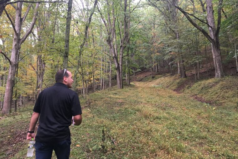Kem Parada, of Finders Keepers, heads uphill in Dents Run, the Elk County location where he and his father believe gold is buried.