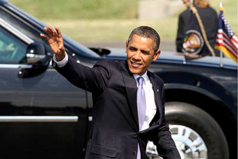 President Barack Obama waves to supporters upon arriving at Philadelphia International Airport, in Philadelphia on Thursday. (AP Photo / Joseph Kaczmarek)