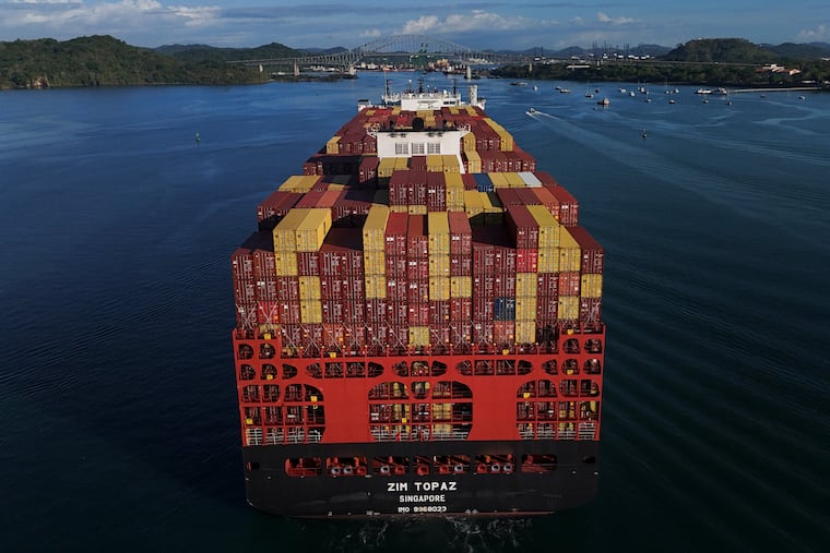 Cargo containers are stacked on a cargo ship moving through the Panama Canal, at sunrise in Panama City, March 25, 2026.