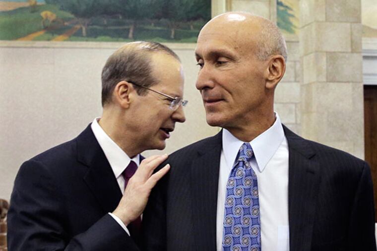 New Jersey's Supreme Court Chief Justice Stuart Rabner, left, greets Superior Court Judge Lee Solomon after Rabner addressed the Senate Judiciary panel during his re-nomination hearing Monday, June 16, 2014, in Trenton, N.J. (AP Photo/Mel Evans)