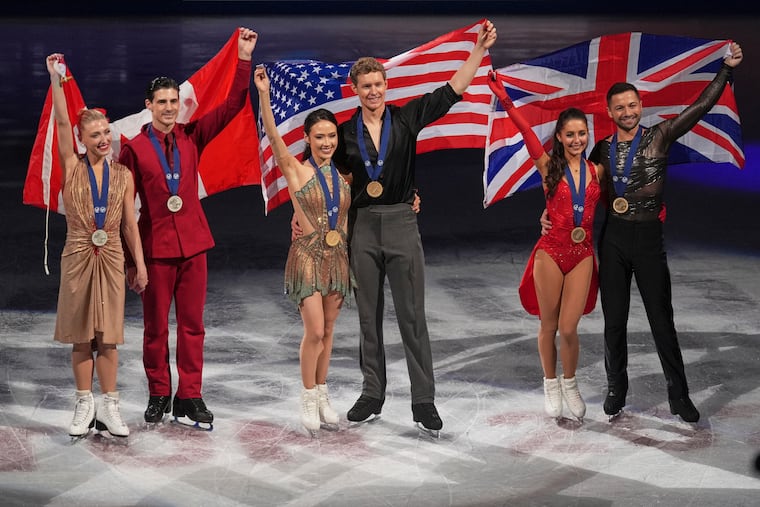 Silver medalists Piper Gilles and Paul Poirier (left), gold medalists Madison Chock and Evan Bates, and bronze medalists Lilah Fear and Lewis Gibson celebrate their medals at worlds in 2025.