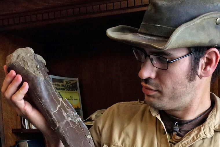 Paleontologist Robert DePalma of the Palm Beach Museum of Natural History, with a Dakotaraptor fossil. It was "a turkey from hell," he says.