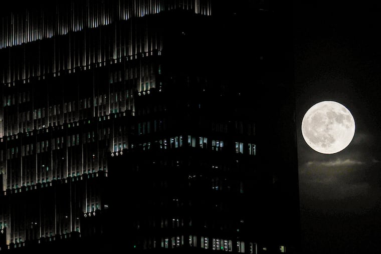 A strawberry moon sometimes called a honeymoon for the full moon of June over the Philadelphia skyline, Friday, June 20, 2024