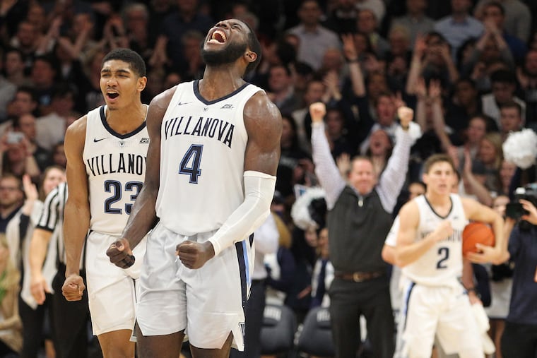 Jermaine Samuels, left, and Eric Paschall, center, of Villanova let out screams after they defeated St. John’s 76-71 at Finneran Pavilion on Jan. 8, 2019.