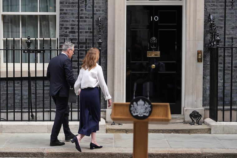 Britain's Prime Minister Keir Starmer and wife Victoria walk back inside 10 Downing Street after speaking to the media in London, Monday, June 22, 2026.