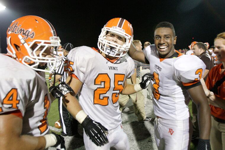 Perkiomen Valley's Anthony Rotonda celebrates his fourth-quarter interception with teammates Pat Delaney and Dakota Clanagan earlier this month. (Elizabeth Robertson/Staff Photographer)