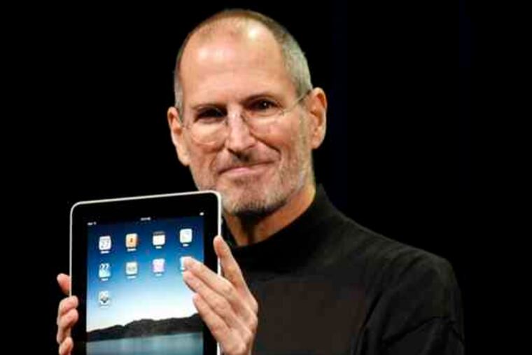 Apple CEO Steve Jobs with the new iPad during a news conference in San Francisco. "It takes what many people like about the iPhone and extends it to a larger device," one observer said.