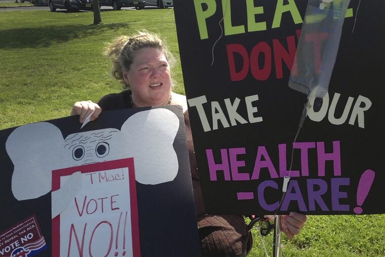 Laurel Smith, 56, of Medford, N.J., attends a protest outside the office of Rep. Tom MacArthur of R-NJ., in Marlton, N.J., Friday, April 28, 2017. She says she's concerned that repeal of the Affordable Care Act could affect health insurance coverage for her son, 26-year-old son, Jamieson Smith, who has a rare sickness called mitochondrial disease. (AP Photo/Mike Catalini)